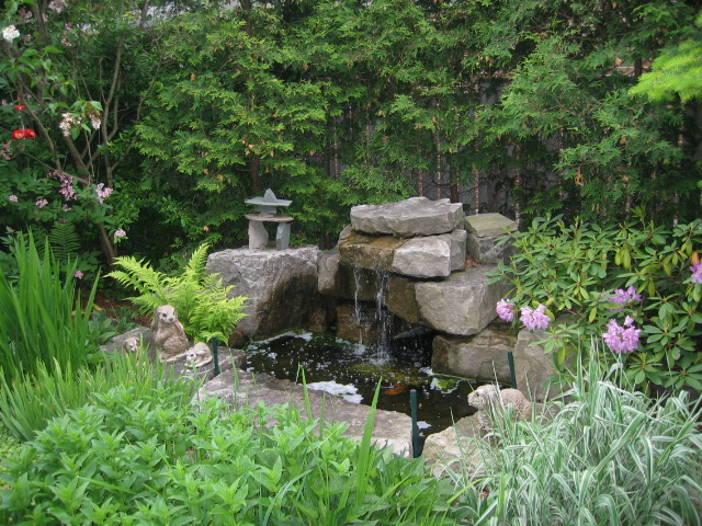 Koi pond surrounded by hand-laid stonework